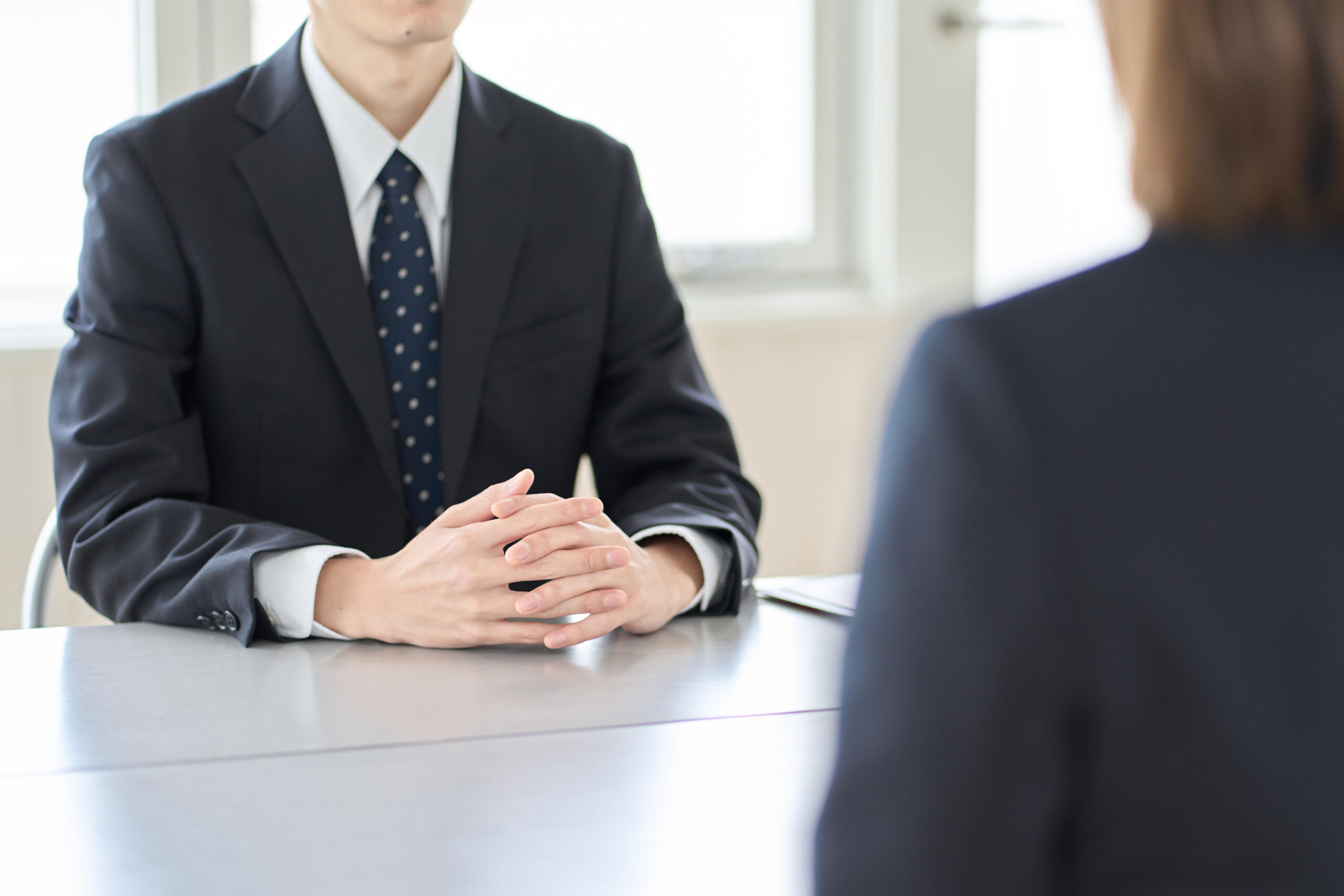 A man speaking with a recruiter during a marketing job interview.